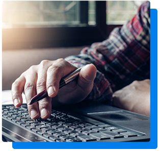 Man with pen in hand using computer